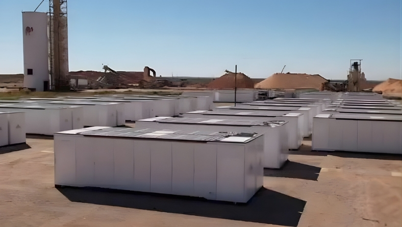 Rows of containerised battery storage units at an industrial site