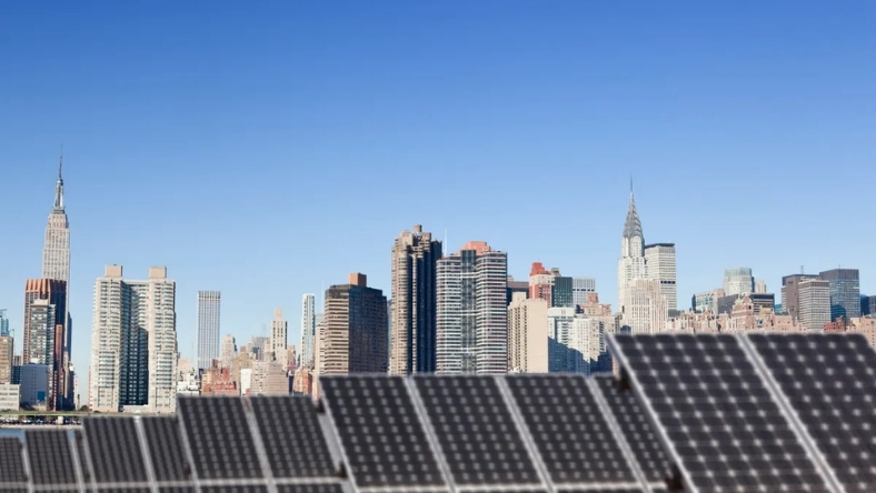 Solar energy panels facing metropolitan skyline