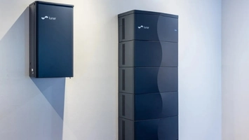 Two dark blue Lunar Energy home battery systems in different sizes mounted against a white wall